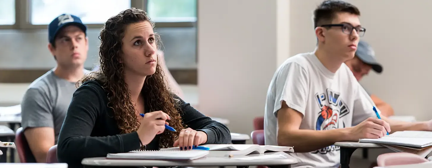 A group of students taking notes in a psychology class.